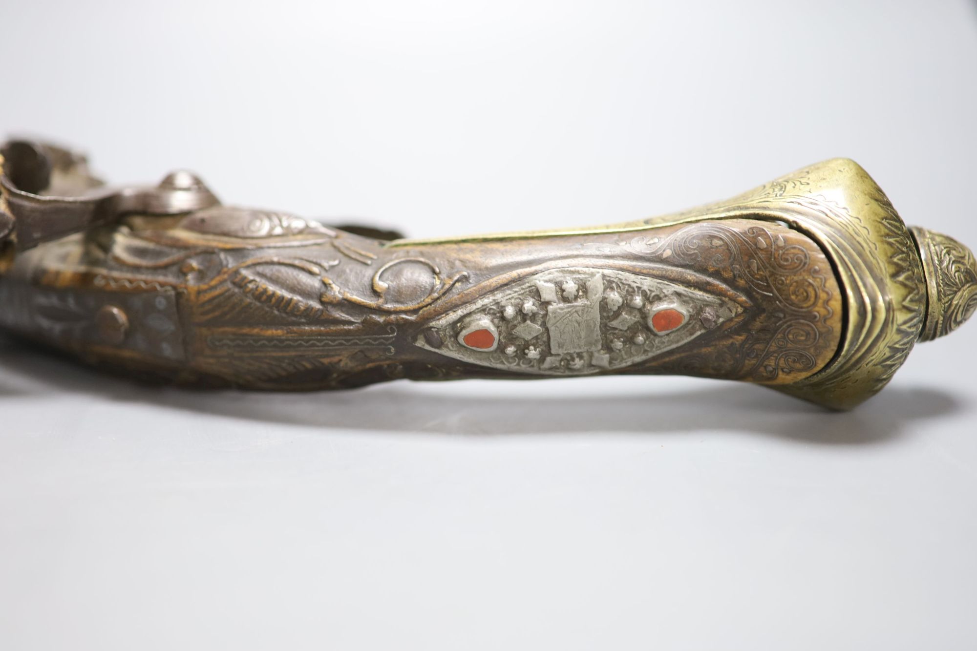 A 19th century Ottoman carved wood and brass mounted flintlock pistol, length 45cm